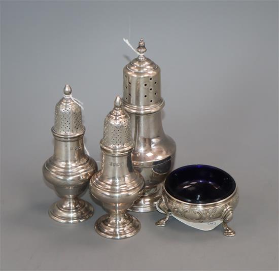 A pair of George V silver baluster-shaped peppers, London 1916, a silver sugar caster and a George III cauldron salt 12oz